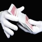 White gloves shuffling cards